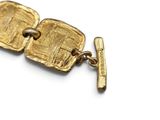 an image of a close up of a gold bracelet with a clasp