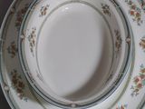 three plates and a bowl sitting on a table