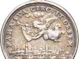 a close up of a silver coin with a statue on it
