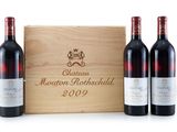 three bottles of wine in front of a wooden box