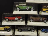 many different model cars on display in a display case