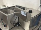 two stainless steel sinks sitting on a counter in a kitchen