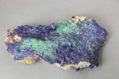 a close up of a piece of rock with blue and green speckles