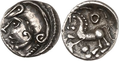 a silver coin with an image of a horse on it