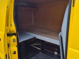 a small bed in the back of a yellow van