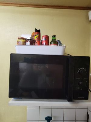 a microwave sitting on top of a counter in a kitchen