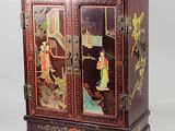 a wooden cabinet with a painting on it