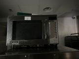 a microwave sitting on top of a counter in a kitchen