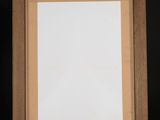an empty picture frame hanging on a shelf in a room
