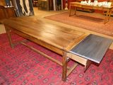 a wooden table with a metal top in a room