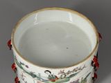 a white cup with a red handle on a table
