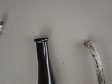 a bottle of beer next to a bone on a table