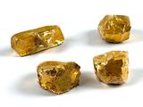 several pieces of gold are arranged in a circle on a white surface