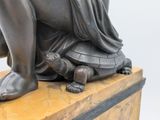 a statue of a woman sitting on top of a turtle