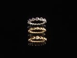 a close up of a stack of rings on a black surface