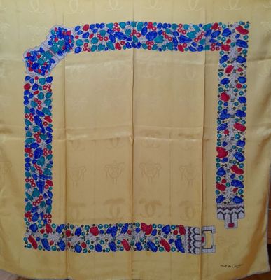 an image of a yellow table cloth with blue and red flowers on it