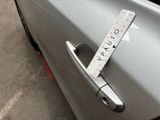 a measuring tape attached to the door handle of a car
