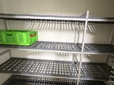 a metal shelf with baskets on it in a room