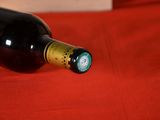 a bottle of wine sitting on a red cloth