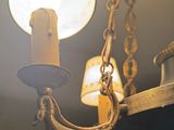a light that is hanging from a chandelier in a room