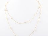 a white pearl and gold necklace on a white mannequin mannequin mannequin mannequin mannequin mannequin mannequin manne