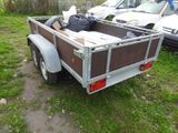 a small trailer with a bed in the back of it