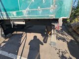 a shadow of a person standing in front of a truck
