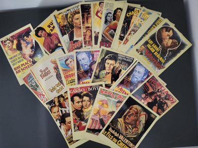 a lot of old movie posters on the table