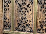 a close up of a wooden door with a decorative design on it