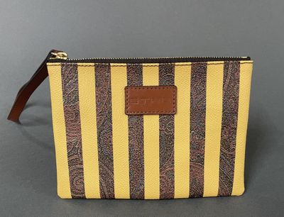a yellow and brown striped purse with a brown leather handle