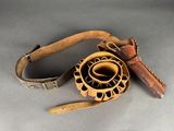 a wooden object with a leather strap around it