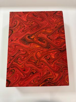a red and black painting on a white surface