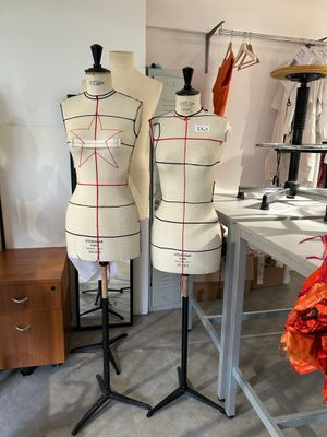 three mannequins on a table in a room