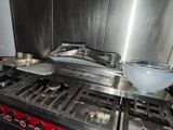 a stove with a bowl on top of it in a kitchen