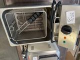 an image of a commercial fryer with a basket inside