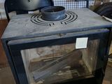 a stove that is sitting in the middle of a room