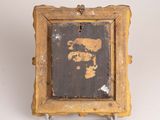 an old wooden picture frame with a picture of a man on it