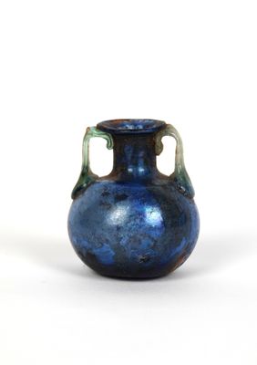 a blue vase that is sitting on a white surface