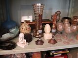 a shelf that has many different types of glass on it