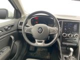 the interior of a car with a steering wheel and dashboard controls