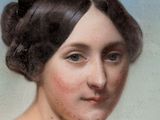 portrait of a woman in a white dress with her hair in a bunt
