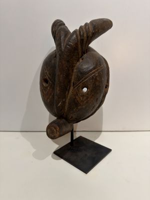 an image of a wooden sculpture of a bird on a stand