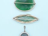 three different types of broochets and pendants on a blue background