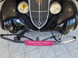 a black car that is on display in a showroom