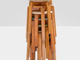 a stack of wooden stools sitting on top of each other