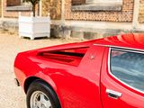 a red sports car parked in front of a brick building