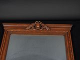 a mirror with a bird on the top of it