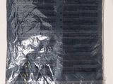 a bag of black fabric on a white surface