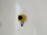 a yellow traffic light on the wall of a building