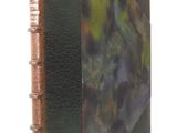 an old book with a leather cover with a picture of a cat